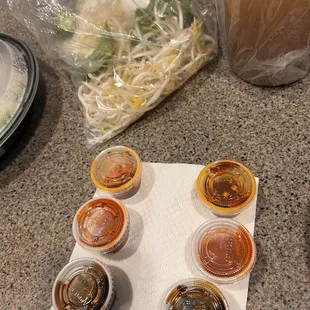 Sauces to add to the broth to make it spicy. Also- bag of bean sprouts, sliced jalapeños, and lime wedges to add to the broth.