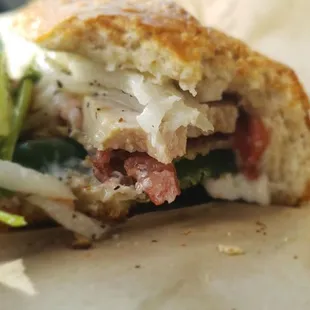 a half eaten sandwich on a piece of paper