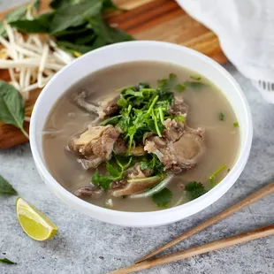 a bowl of soup and chopsticks