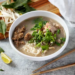 a bowl of soup with meat and noodles