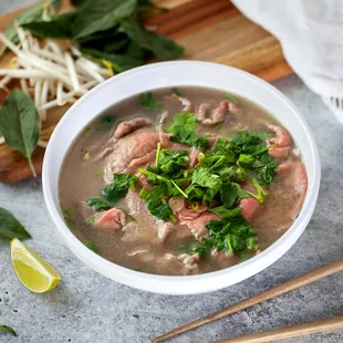 a bowl of soup and chopsticks