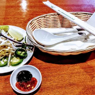 a bowl of noodles and chopsticks