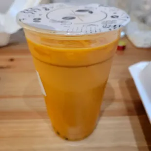 a plastic cup with a lid on a wooden table