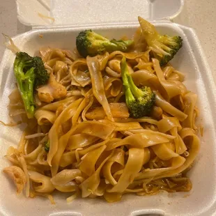 noodles and broccoli in a styrofoam container