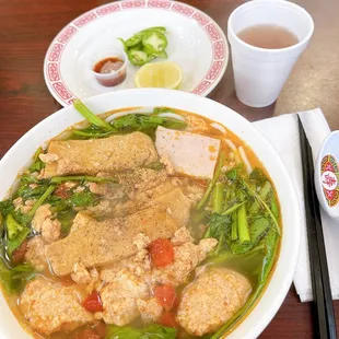 a bowl of soup and chopsticks