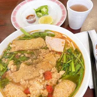 a bowl of soup and chopsticks