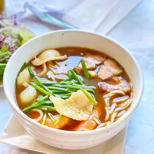 a bowl of soup and a salad