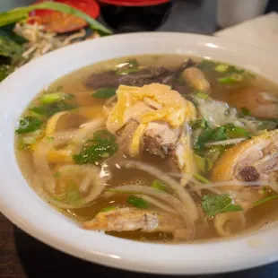 a bowl of soup with meat and vegetables