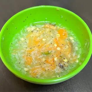 a green bowl of soup