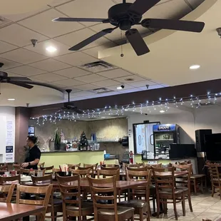 a restaurant with a ceiling fan