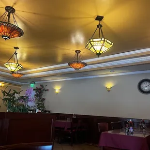 a dining room with a clock on the wall
