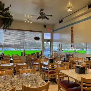 a dining area with tables and chairs