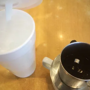 a blender and a cup on a table