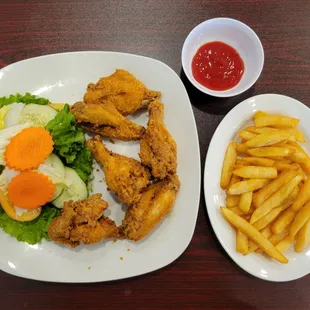 Cánh Gà Chiên Nước Mắm(Buffalo Chicken Wings) with fries and spicy ketchup.