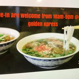 a bowl of soup with chopsticks