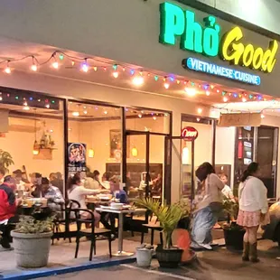 people eating outside of a restaurant