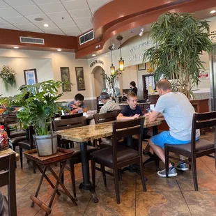 people sitting at tables in a restaurant