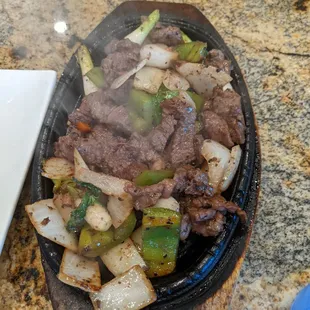 beef and vegetables cooking in a skillet