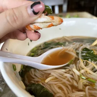 a person eating a bowl of soup