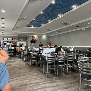 a man sitting at a table in a restaurant