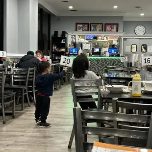 people sitting at tables in a restaurant