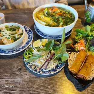 Vegetarian pho with a side of chicken, and egg rolls