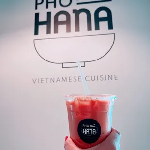 a hand holding a drink