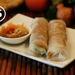 Crispy vegan tofu spring rolls filled with fresh veggies and herbs, wrapped to perfection. Paired with tangy sauce.