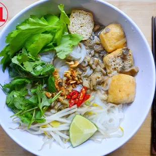 Vegan noodle soup features rice noodles, veggies, tofu, herbs, and spiced broth, offering a comforting, fresh, and flavorful plant based mea