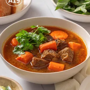 Savory Bò Kho--rich, tender beef stew with aromatic spices, served with bánh mì. A comforting Vietnamese favorite!