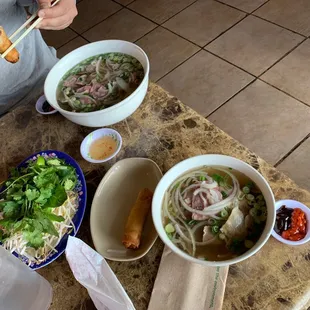 a person eating a bowl of pho hau