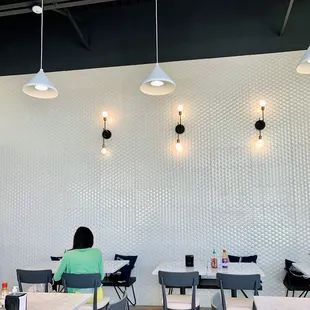 a woman sitting at a table in a restaurant