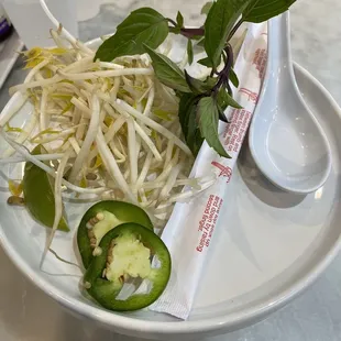 a plate of sprouts and a spoon