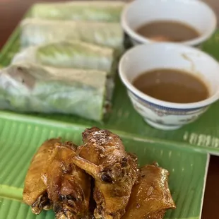 Chicken wings and grilled pork rolls