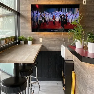 a bar with stools and a television