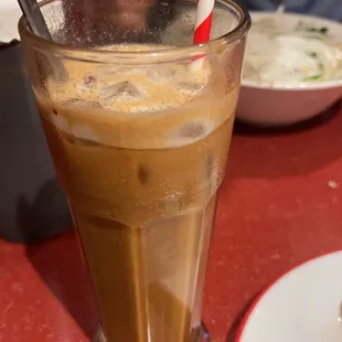 a glass of iced coffee and a plate of food