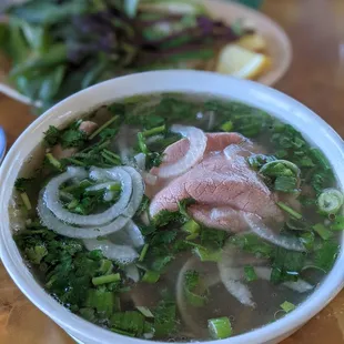 a bowl of soup with meat and vegetables