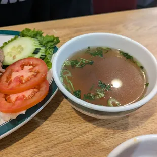 Side of broth for the grilled pork and rice