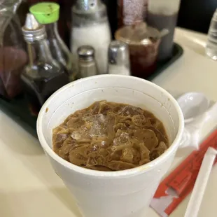 a bowl of soup and spoons on a table