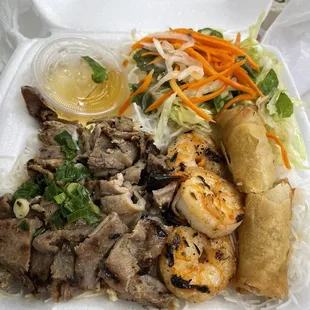 combo dish shrimp egg rolls and pork grilled.