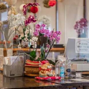 a counter with flowers and a laptop