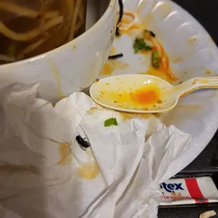 a bowl of soup and a spoon on a plate