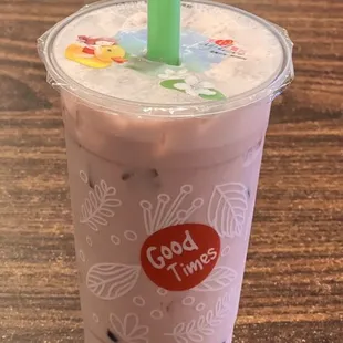 a strawberry milkshake in a plastic cup with a straw