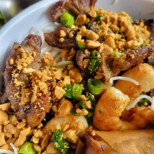 a bowl of noodles with meat and vegetables