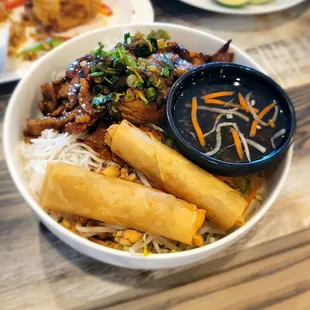 E6 vermicelli with grilled pork and pork egg rolls
