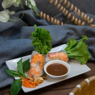 a plate of shrimp with dipping sauce