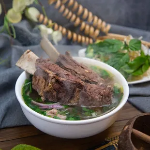 a bowl of soup with meat and vegetables