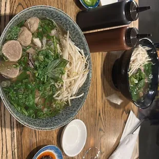 a bowl of pho noodle and a glass of wine