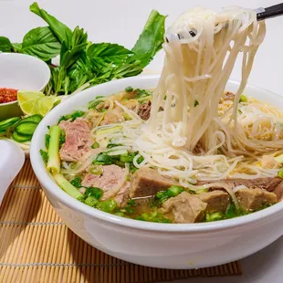 a bowl of noodles with meat and vegetables