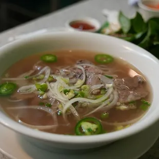 a bowl of soup and chopsticks